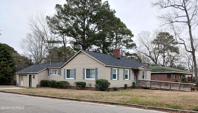 single story home with a deck and a garage