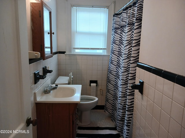 bathroom featuring oversized vanity, tile flooring, toilet, backsplash, and tile walls