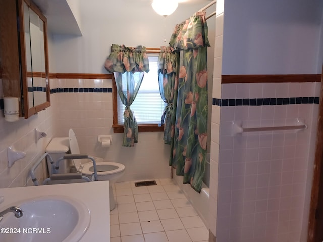 full bathroom with toilet, shower / bath combo, vanity, tile walls, and tile floors