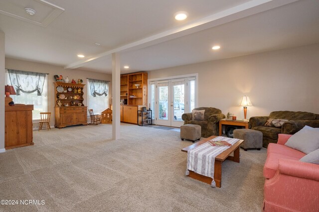 living room with light colored carpet, french doors, and beam ceiling