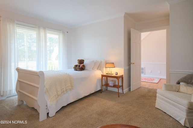 carpeted bedroom featuring ornamental molding