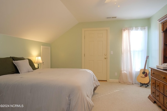 carpeted bedroom with ceiling fan and lofted ceiling