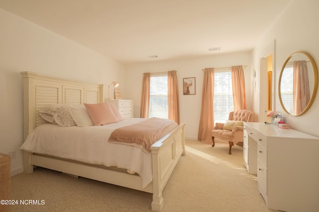 bedroom featuring light colored carpet