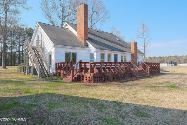 back of house featuring a deck and a yard