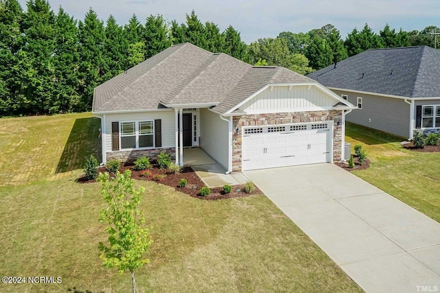 craftsman-style house featuring a garage and a front yard