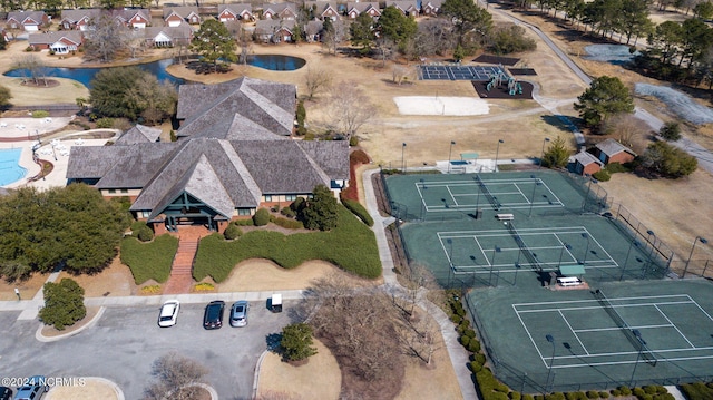 aerial view of property and surrounding area with nearby suburban area and a large body of water