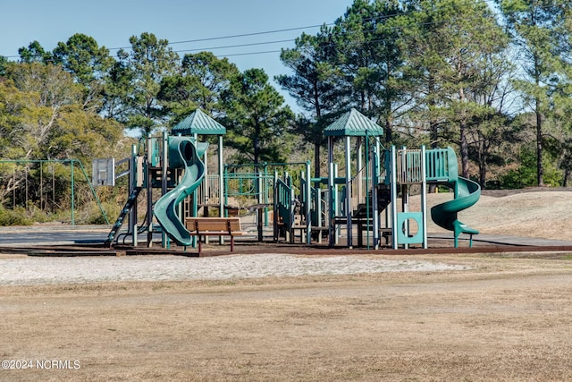 community play area featuring view of wooded area