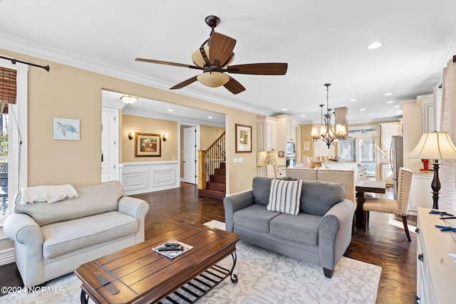 living room with a barn door, hardwood / wood-style floors, crown molding, and ceiling fan with notable chandelier