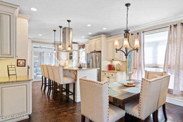 dining space featuring a chandelier, a wealth of natural light, ornamental molding, and dark hardwood / wood-style flooring