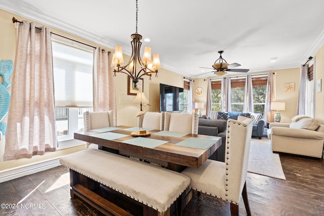 dining space featuring ornamental molding, dark wood-type flooring, and ceiling fan with notable chandelier