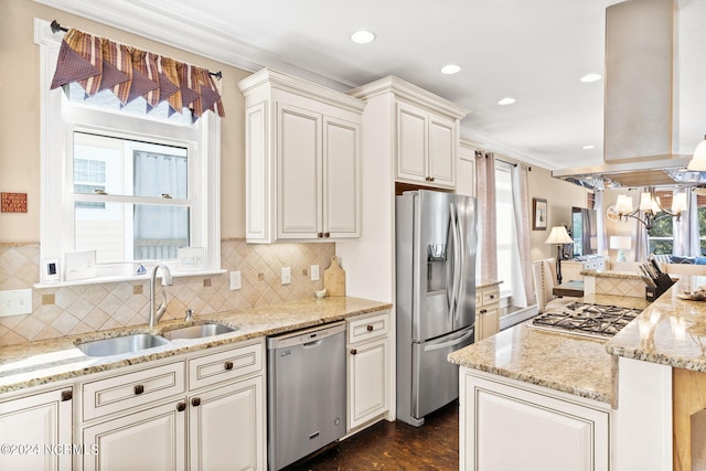 kitchen featuring tasteful backsplash, stainless steel appliances, sink, and an inviting chandelier