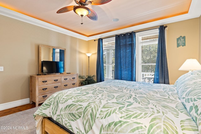 bedroom with ceiling fan, crown molding, and wood-type flooring