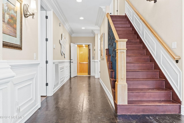 stairway featuring crown molding and dark hardwood / wood-style flooring