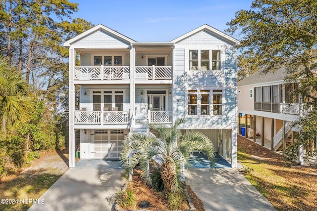 raised beach house with a balcony and a garage