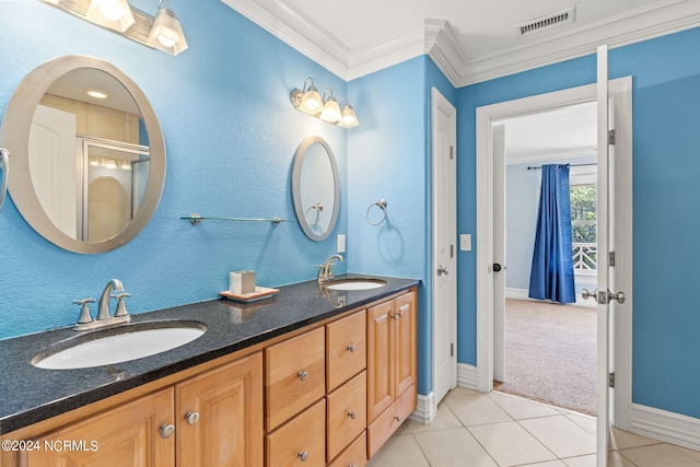 bathroom with dual sinks, tile floors, ornamental molding, and vanity with extensive cabinet space