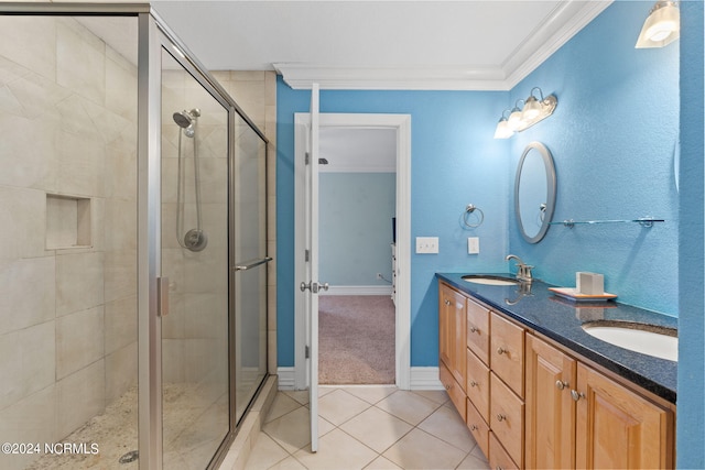 bathroom with double sink vanity, tile flooring, walk in shower, and crown molding