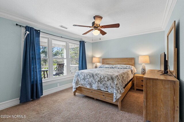 bedroom with ceiling fan, crown molding, and carpet floors