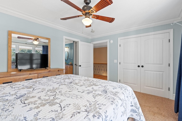 carpeted bedroom featuring ornamental molding, a closet, and ceiling fan