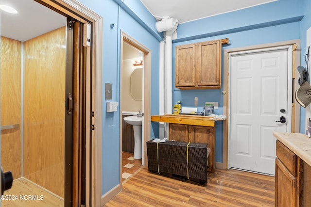 interior space featuring sink and light hardwood / wood-style flooring