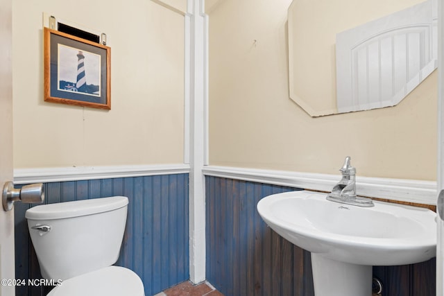 bathroom with tile flooring, toilet, and sink