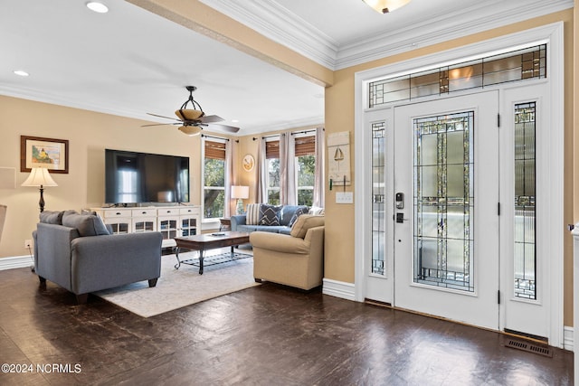 living room with dark wood-type flooring, crown molding, and ceiling fan