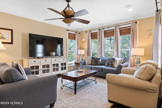 living room featuring crown molding and ceiling fan