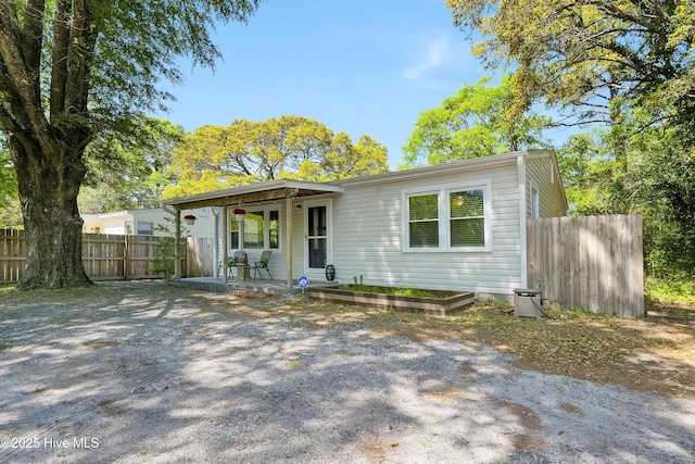view of front facade with a porch and fence