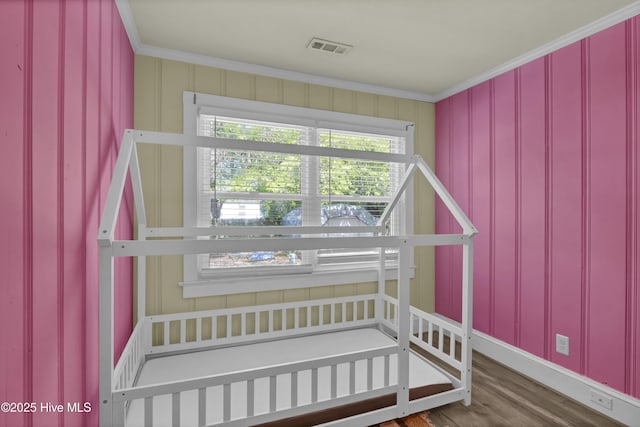 staircase featuring crown molding, wood finished floors, and visible vents