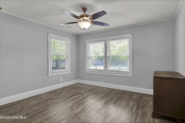 unfurnished room featuring visible vents, baseboards, ceiling fan, crown molding, and wood finished floors