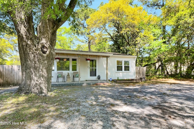 view of front of house with a porch and fence