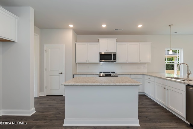 kitchen with white cabinetry, sink, and stainless steel appliances