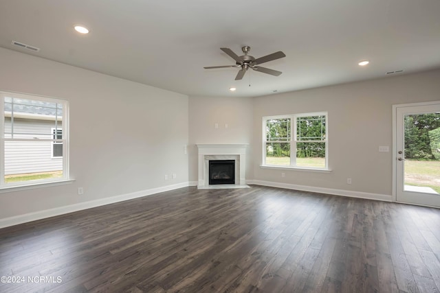 unfurnished living room with ceiling fan and dark hardwood / wood-style flooring