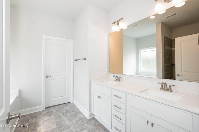 bathroom with vanity and a tub