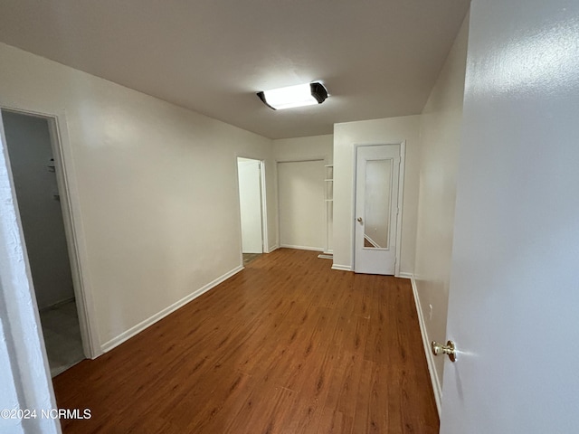 unfurnished room featuring dark wood-type flooring