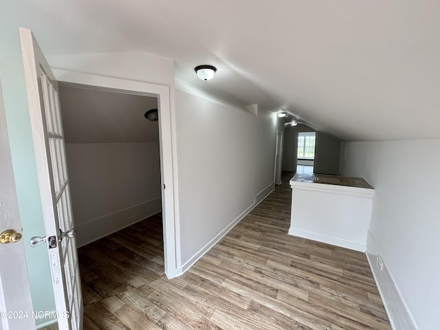 interior space with hardwood / wood-style floors and vaulted ceiling