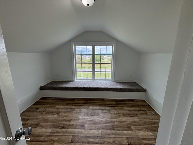 bonus room featuring lofted ceiling and dark hardwood / wood-style floors