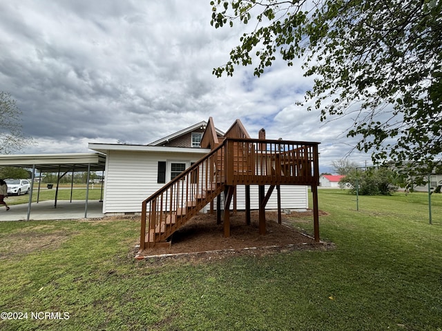 rear view of property featuring a yard, a carport, and a wooden deck