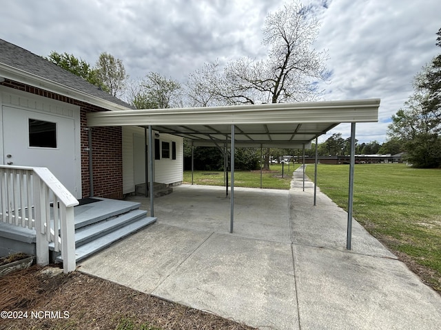 view of car parking with a yard and a carport