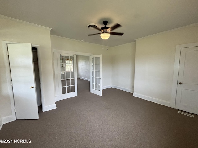 unfurnished bedroom with ceiling fan, dark colored carpet, ornamental molding, and french doors