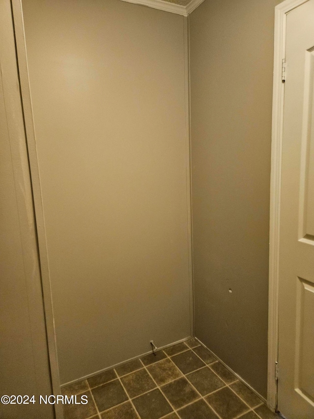 clothes washing area featuring dark tile flooring