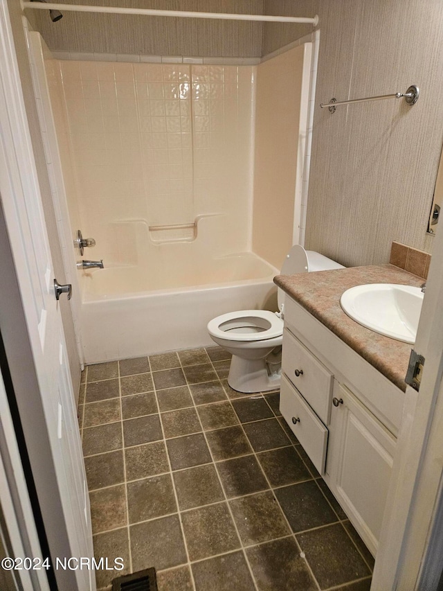 full bathroom with tile floors,  shower combination, toilet, and vanity