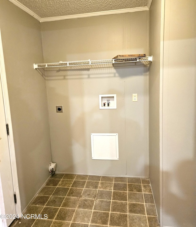 clothes washing area featuring crown molding, electric dryer hookup, dark tile flooring, and hookup for a washing machine