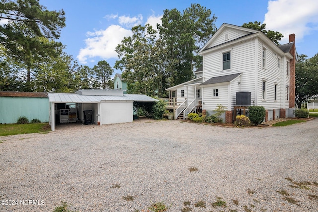 view of side of home featuring an outbuilding and a carport