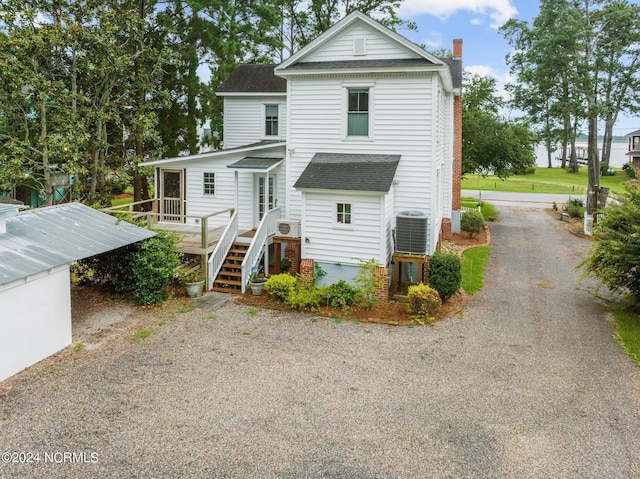 rear view of property with central AC