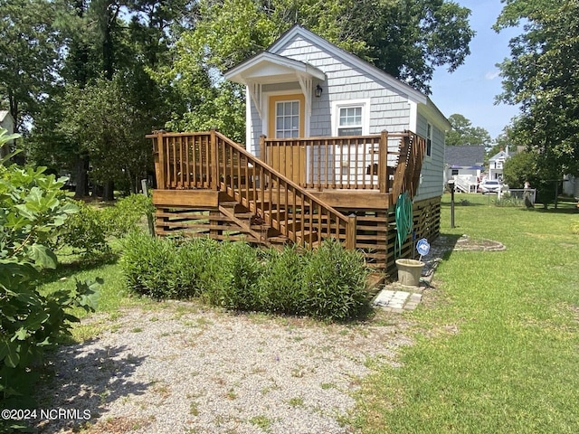 view of front of house with a front lawn and a deck