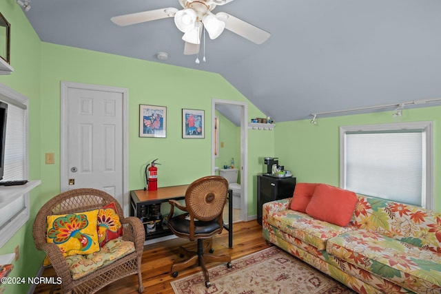 living room featuring ceiling fan, hardwood / wood-style flooring, and lofted ceiling