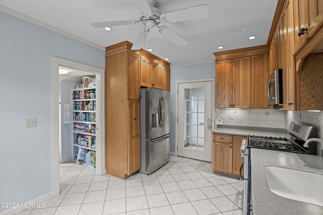 kitchen featuring appliances with stainless steel finishes, light tile patterned floors, tasteful backsplash, and crown molding