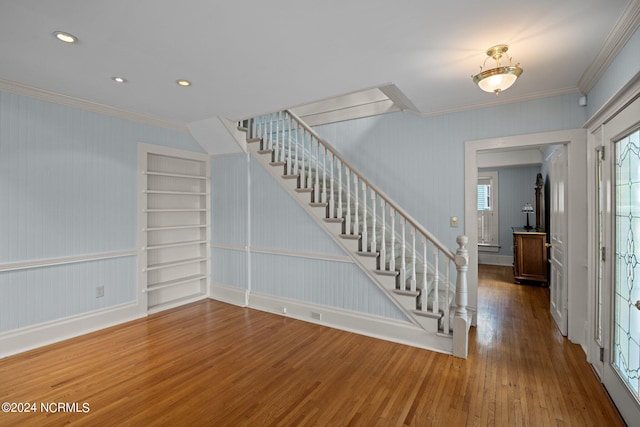 foyer entrance with hardwood / wood-style floors and ornamental molding