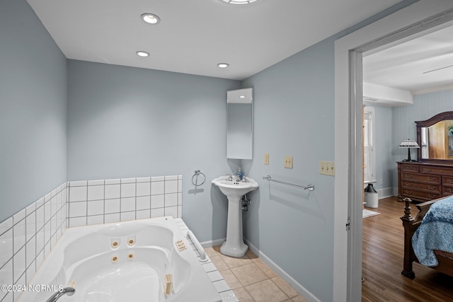 bathroom featuring tile patterned floors and tiled bath