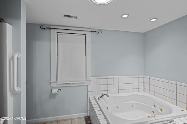 bathroom featuring tile patterned floors and tiled bath